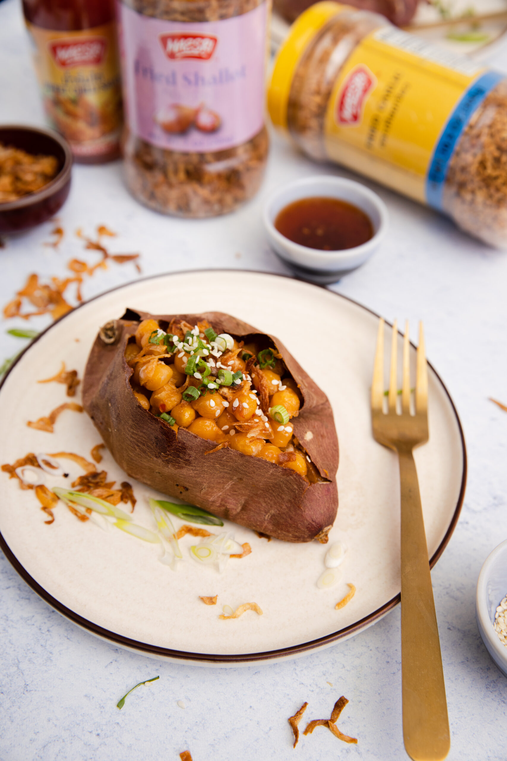 baking tray with fourSticky Chilli Sauce Chickpea-Stuffed Sweet Potatoes